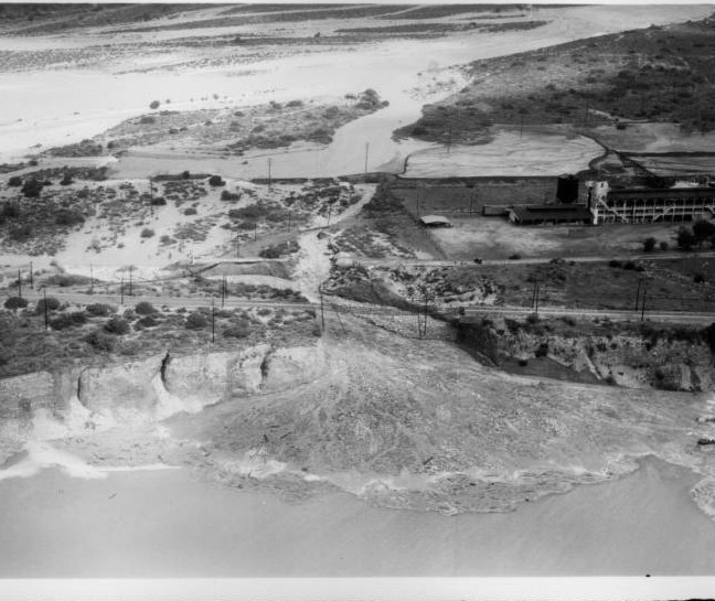 An aerial view of flooding in Azusa after rain water washes out the ground beneath the San Gabriel Railroad tracks, 1938
