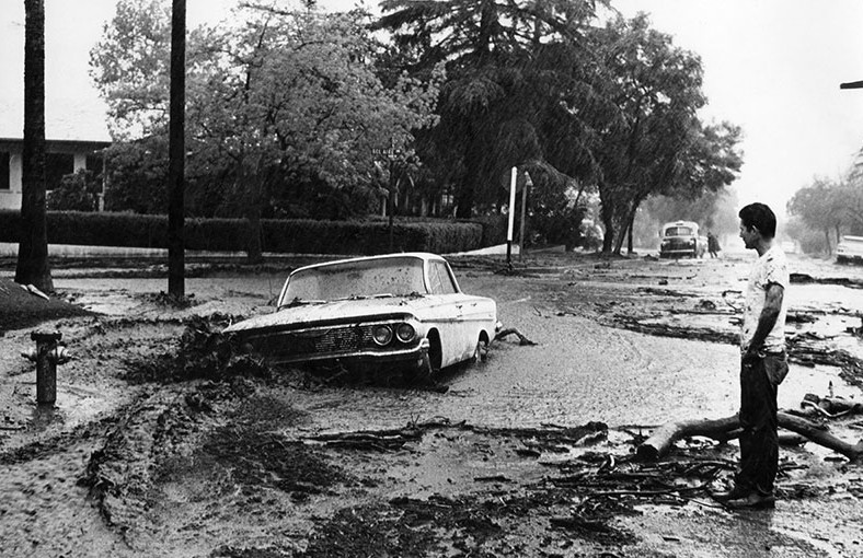 Burbank resident looks at his new car, which floodwaters and a mudslide moved 50 feet down Cypress Street, 1964