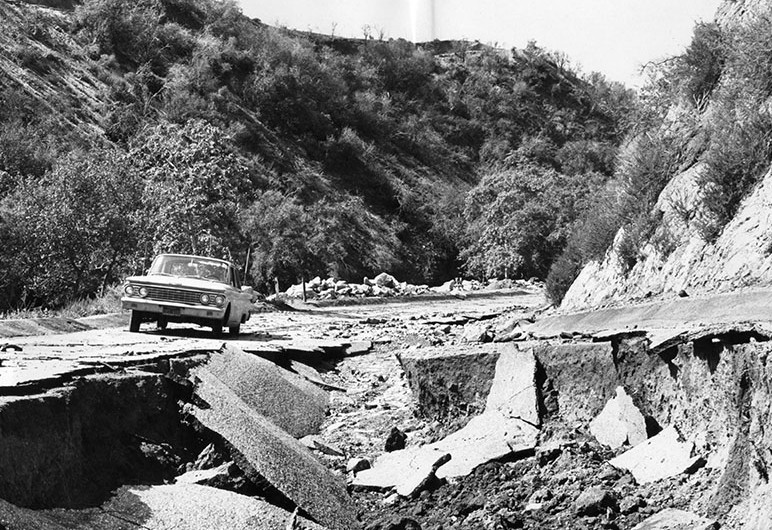 Crumbling pavement from flooding on a street in Burbank's Wildwood Canyon Park, 1965