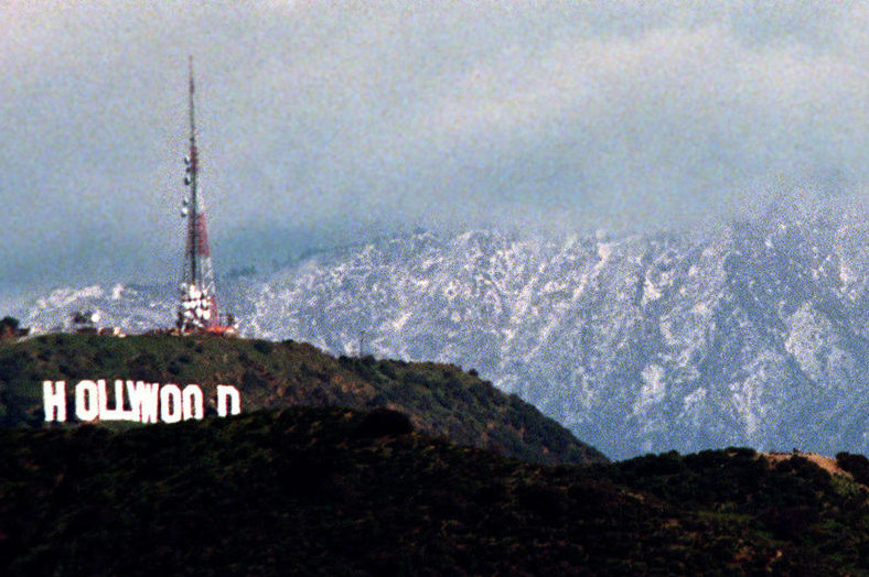 El Niño rain brings snow to lower elevations.  Here, the rare sight of  snow-covered mountains near Los Angeles, 1998