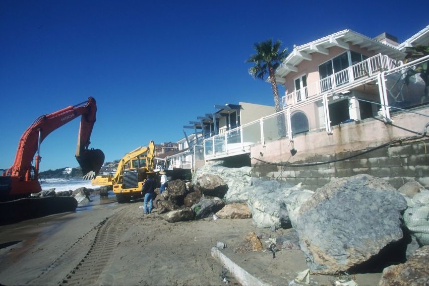 Preparing for what would become the largest El Niño year on record, construction crews  protect beachfront homes with boulders,  1998